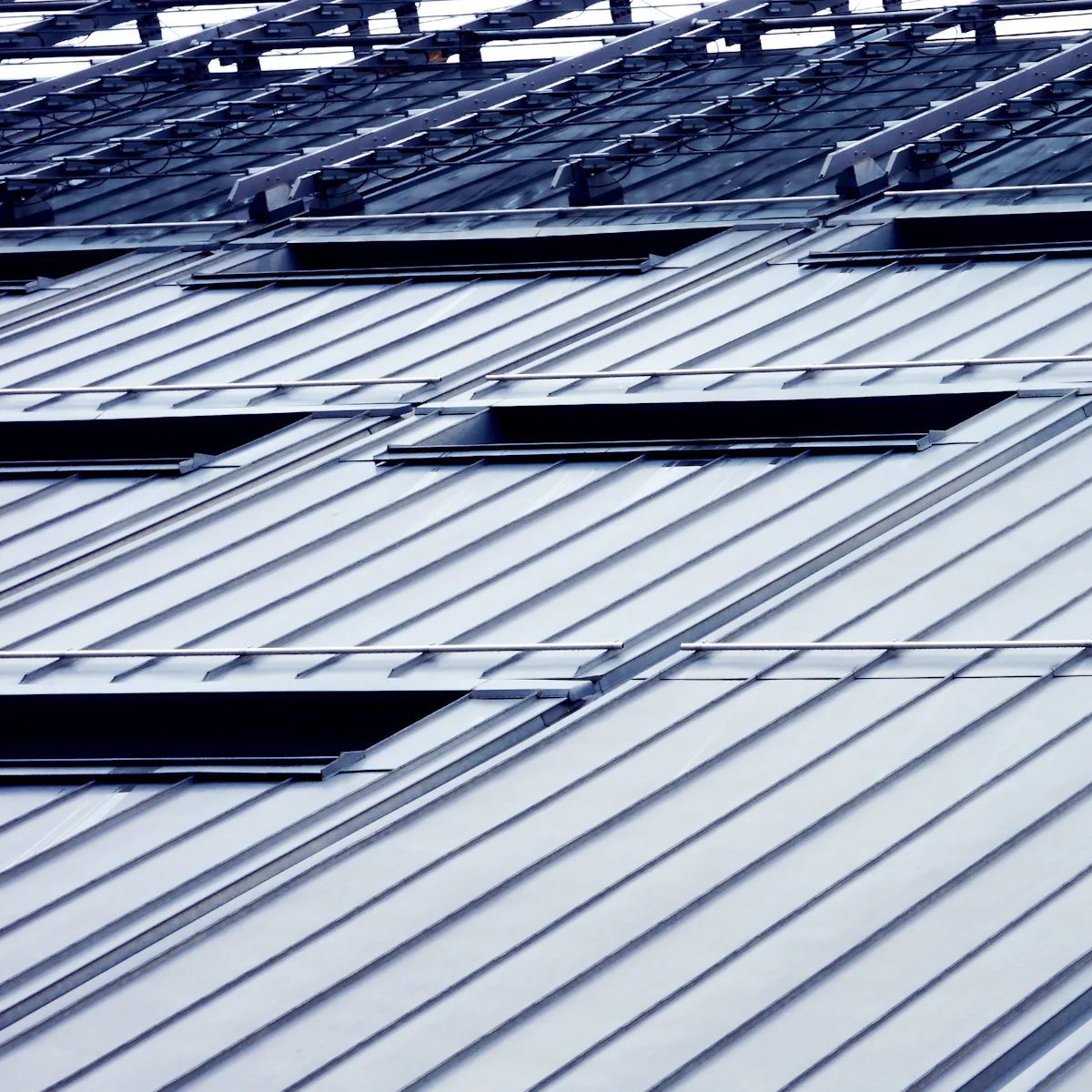 Metal roof panels with skylights
