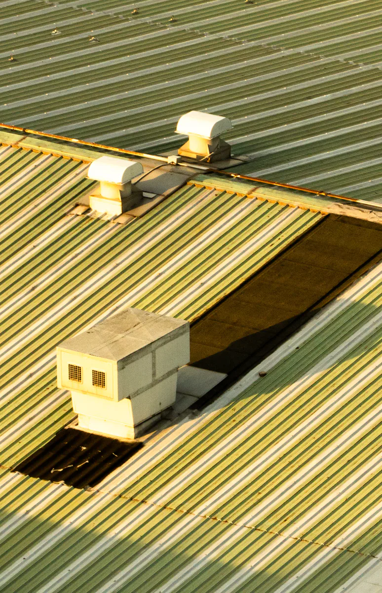 Low-slope roof with vents and roof hatches