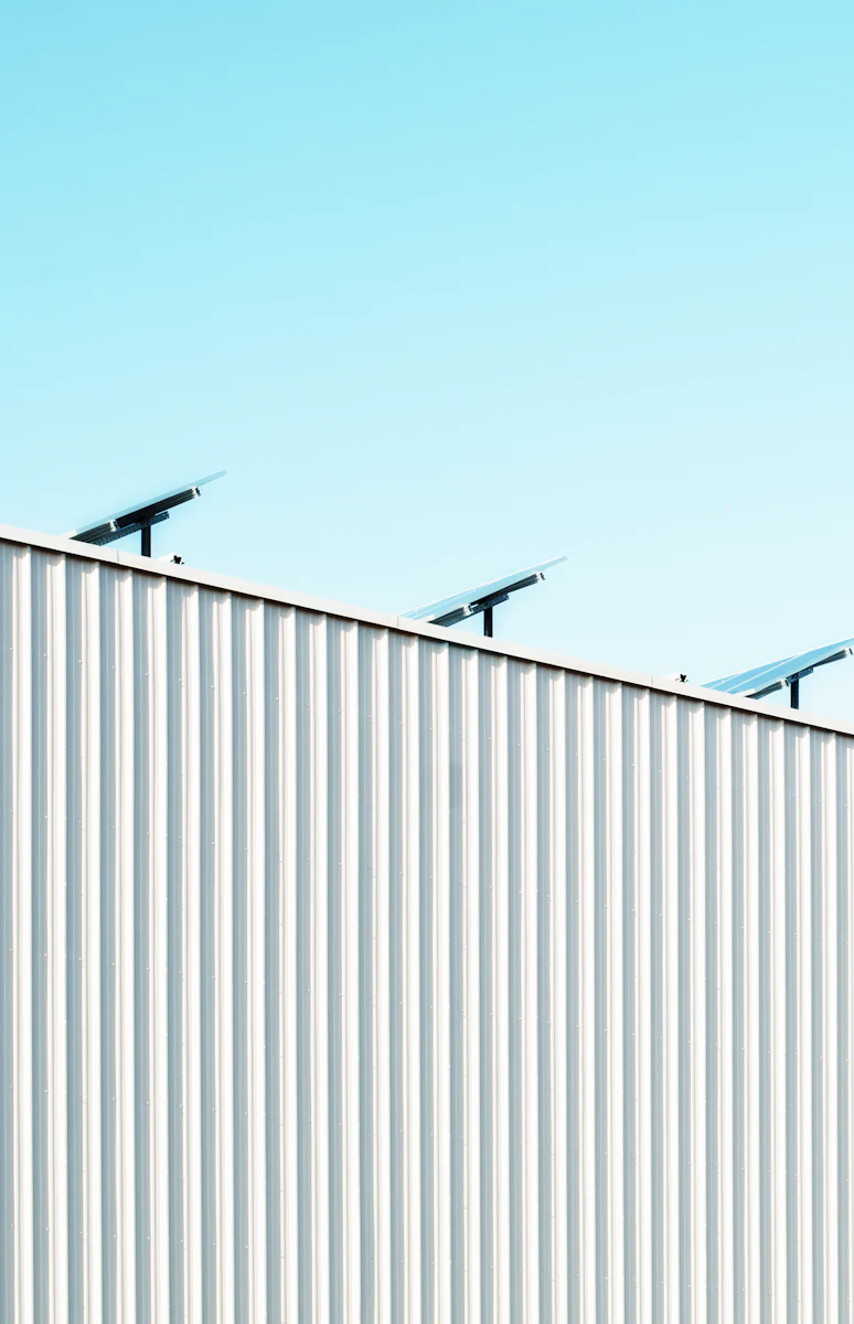 White commercial roof edge with rooftop panels