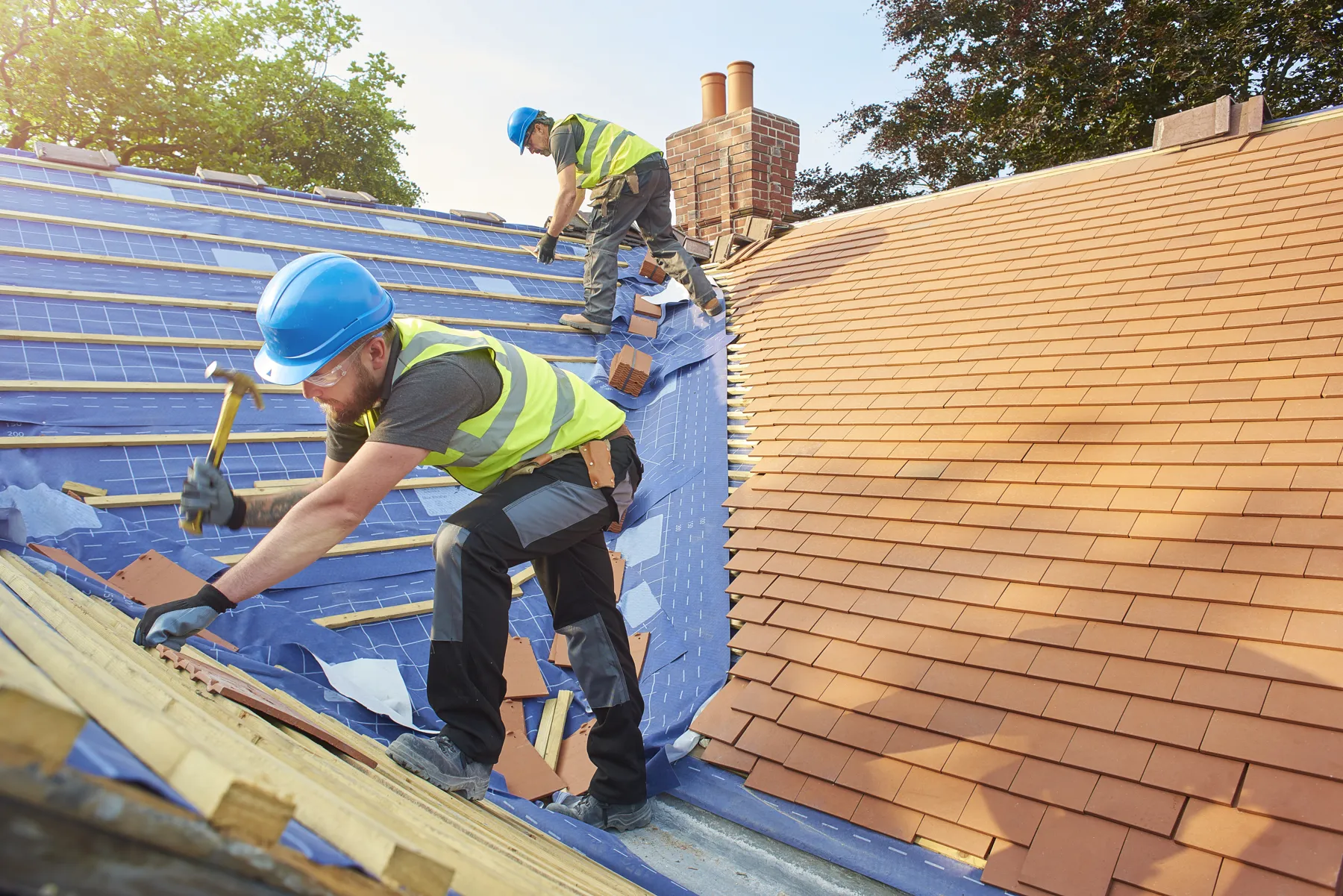 Roofers installing a tile roof